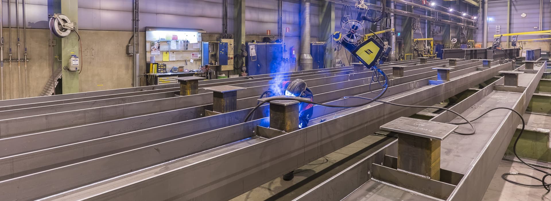 custom steel fabrication process showing structural framing and industrial building envelope.